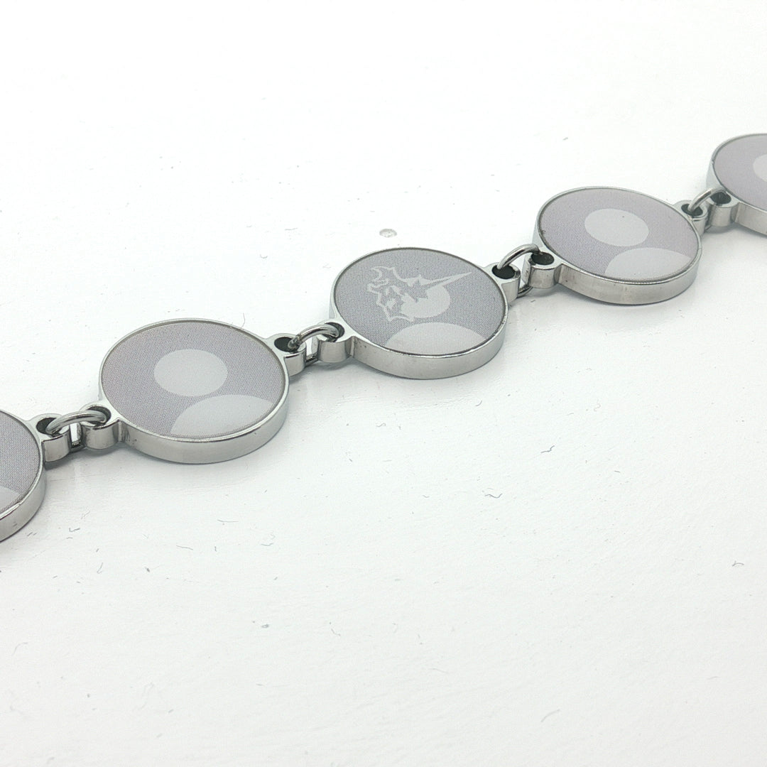 Silver bracelet with circular links on a white background