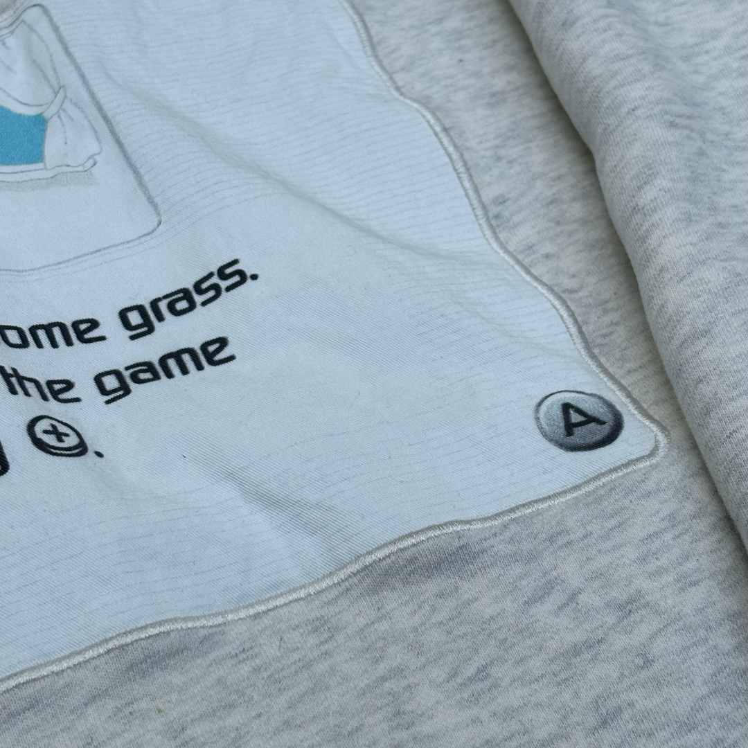 Gray sweatshirt with text and a button on a light gray background